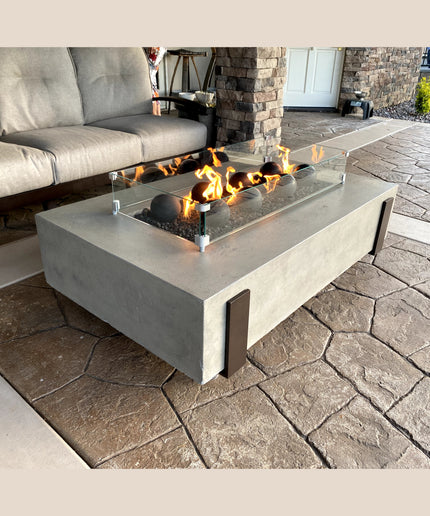American Fyre Designs 60"W x 36"D x 17"H Iron Saddle Firepit Package w/ Lava, Spheres, Wind Guard & Cover - Light Bassalt (NG)